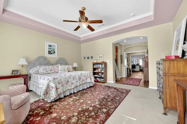 a bedroom with bed and a large mirror