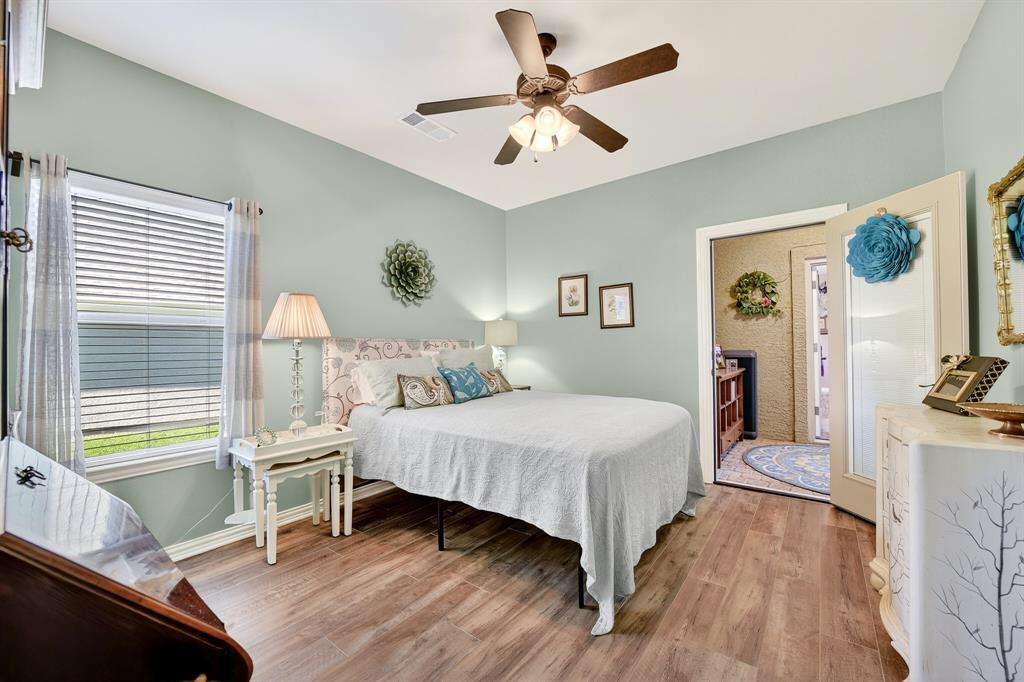 9813 Callaway Court Denton, TX 76207 - Photo 30 of 39 a bedroom with a bed and a chandelier