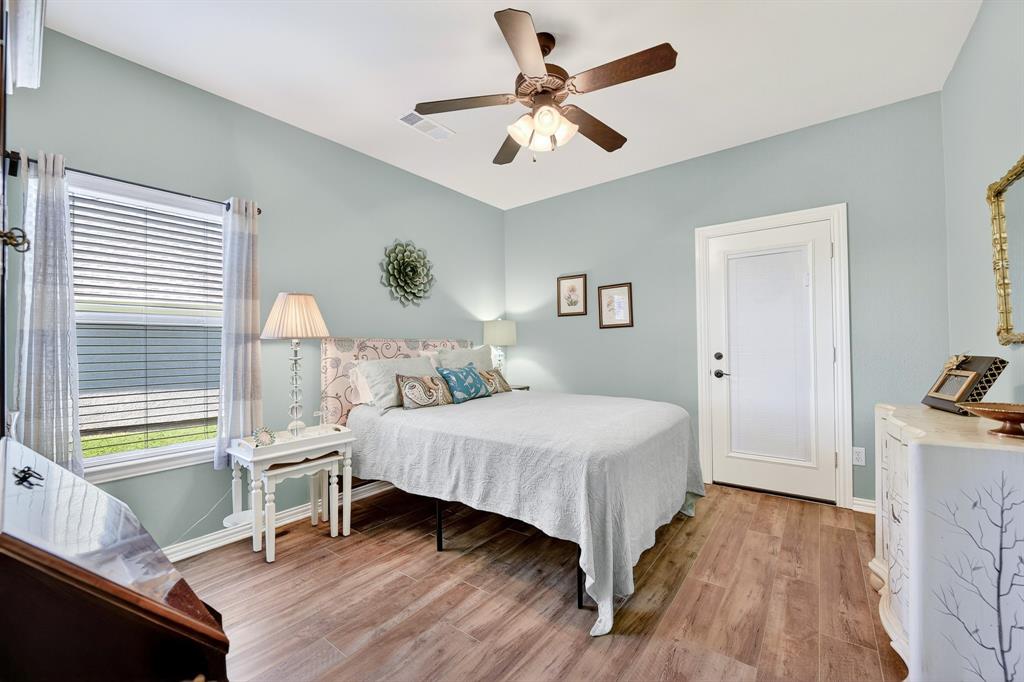 9813 Callaway Court Denton, TX 76207 - Photo 31 of 39 a bedroom with a bed and a chandelier