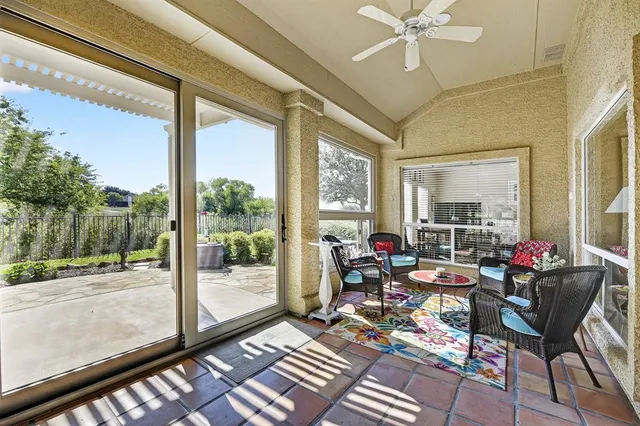 a living room with furniture and a floor to ceiling window