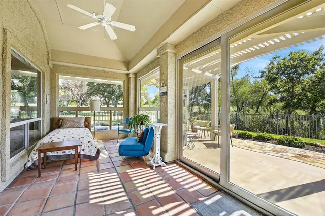 a living room with furniture and a floor to ceiling window