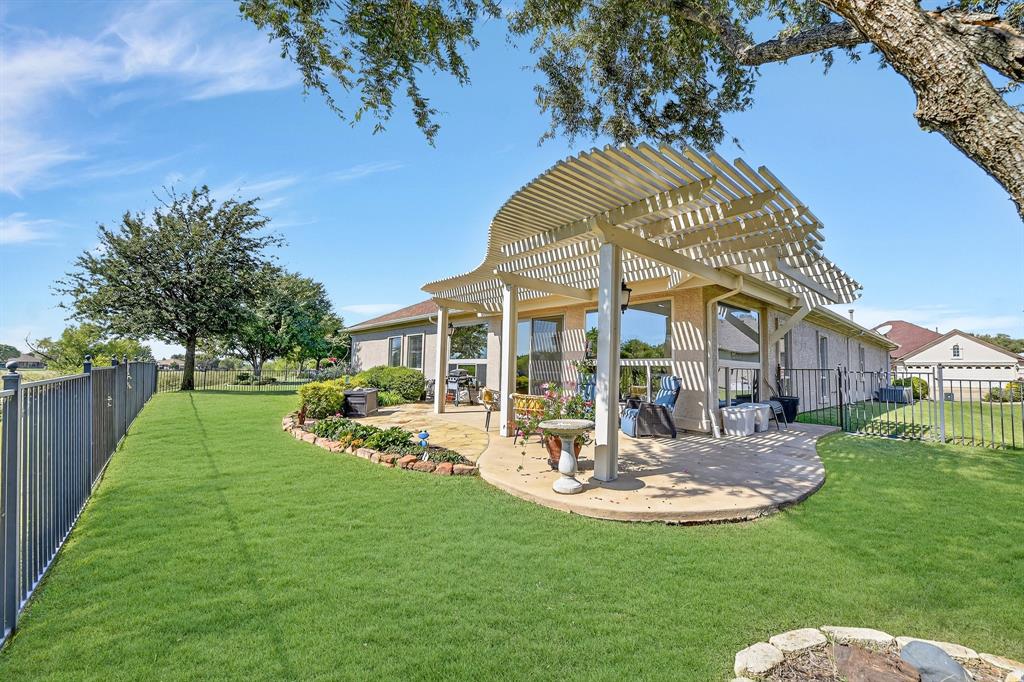 9813 Callaway Court Denton, TX 76207 - Photo 36 of 39 a view of a house with a big yard potted plants and large tree