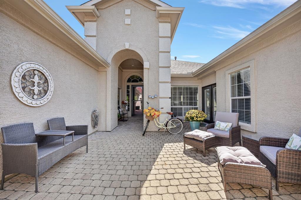 9813 Callaway Court Denton, TX 76207 - Photo 4 of 39 a living room with furniture a clock and a large window