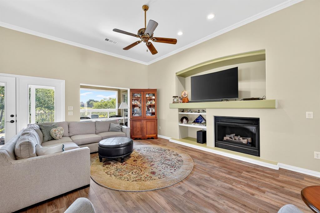 9813 Callaway Court Denton, TX 76207 - Photo 7 of 39 a living room with furniture a flat screen tv and a fireplace