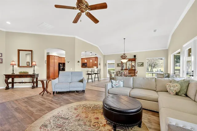 a living room with furniture and a chandelier