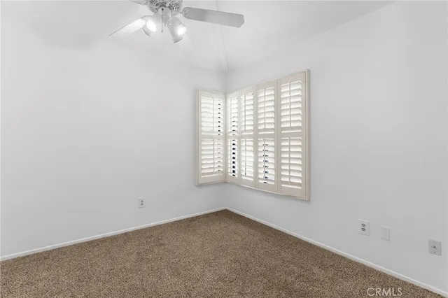 an empty room with windows and entrance