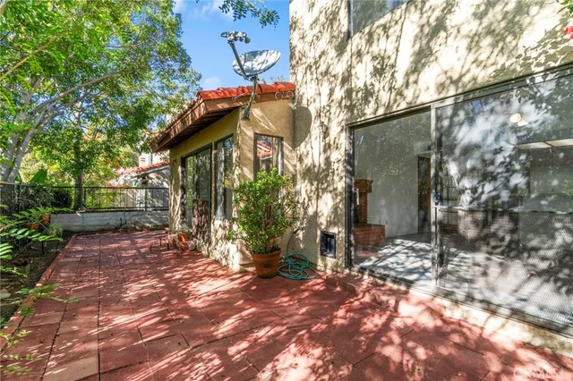 a view of a terrace with a garden and bench