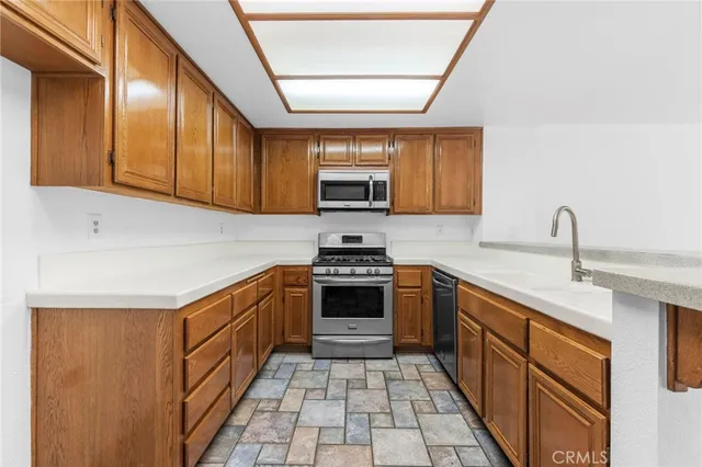 a kitchen with stainless steel appliances granite countertop a stove and a sink