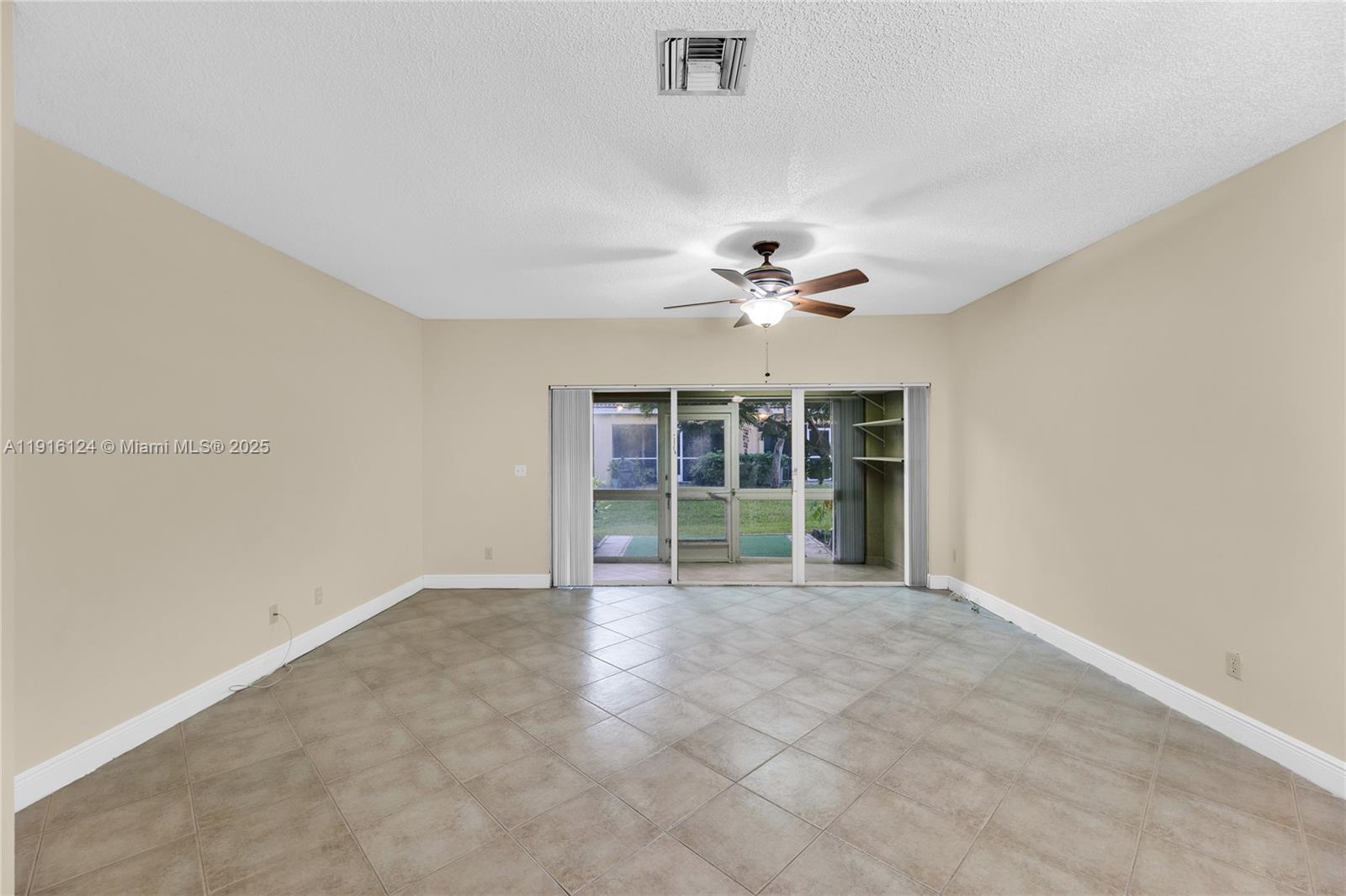 304 Southwest 120th Avenue, Unit 304 Pembroke Pines, FL 33025 - Photo 12 of 46 a view of an empty room with a window
