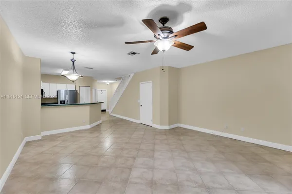 a view of a kitchen with a sink and a ceiling fan