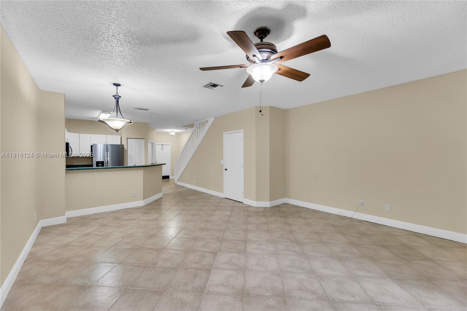 304 Southwest 120th Avenue, Unit 304 Pembroke Pines, FL 33025 - Photo 13 of 46 a view of a kitchen with a sink and a ceiling fan
