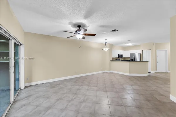 a view of a kitchen with a sink and a chandelier