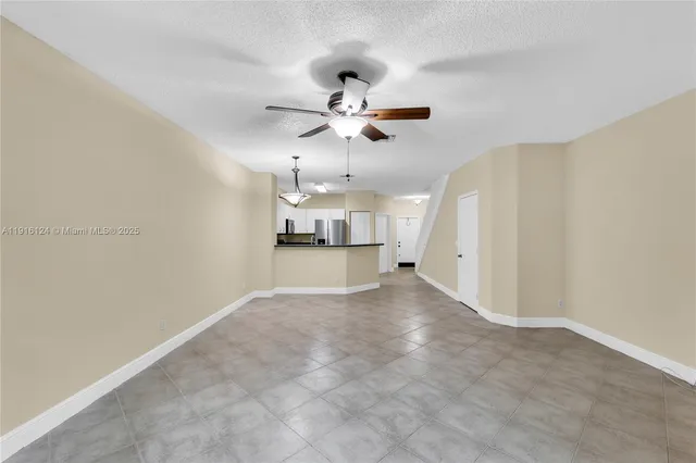 a view of a kitchen with a sink and a chandelier fan
