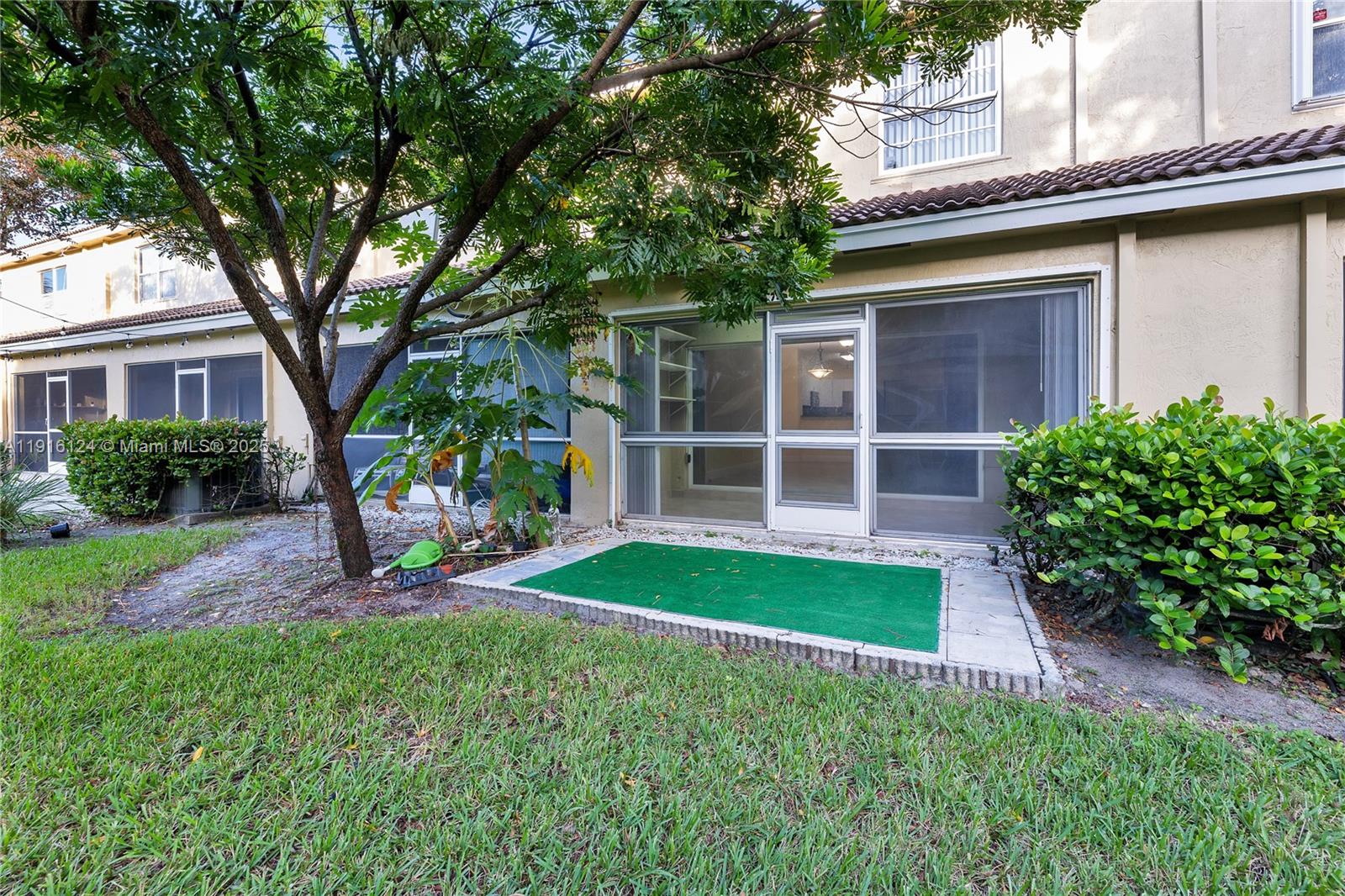 304 Southwest 120th Avenue, Unit 304 Pembroke Pines, FL 33025 - Photo 20 of 46 a view of a house with a garden