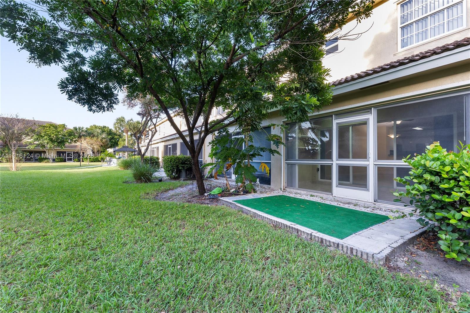 304 Southwest 120th Avenue, Unit 304 Pembroke Pines, FL 33025 - Photo 22 of 46 a view of a house with a yard and sitting area