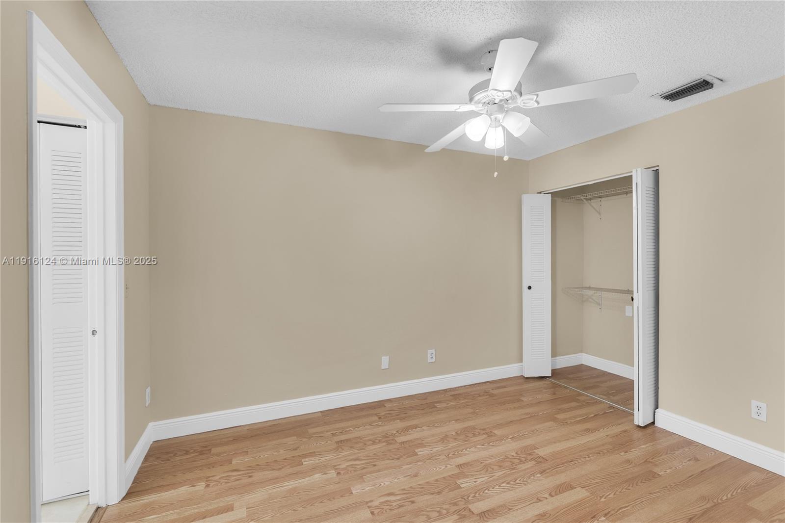 304 Southwest 120th Avenue, Unit 304 Pembroke Pines, FL 33025 - Photo 28 of 46 a view of an empty room with wooden floor