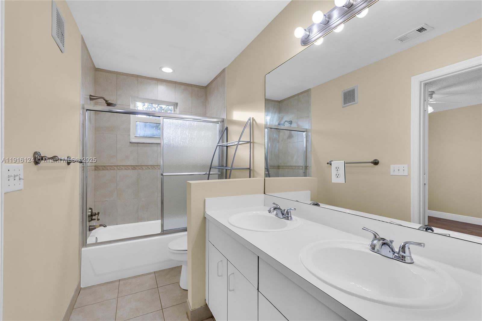 304 Southwest 120th Avenue, Unit 304 Pembroke Pines, FL 33025 - Photo 30 of 46 a bathroom with a sink double vanity and a shower