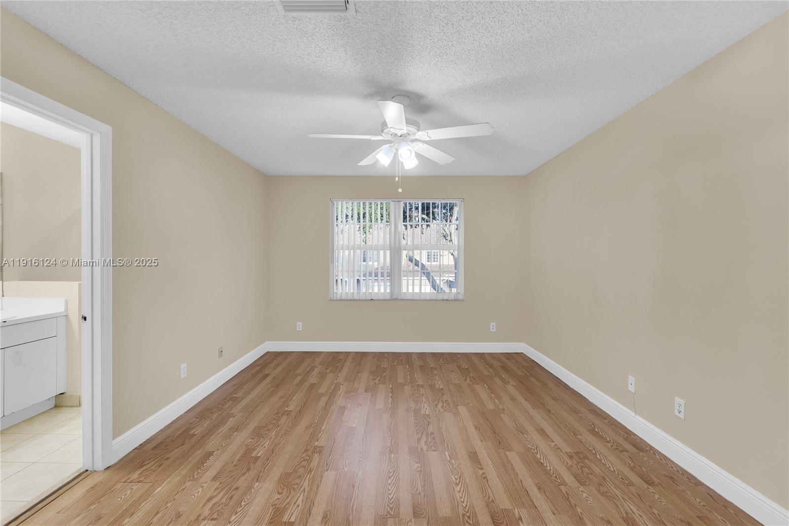 304 Southwest 120th Avenue, Unit 304 Pembroke Pines, FL 33025 - Photo 31 of 46 wooden floor in an empty room with a window