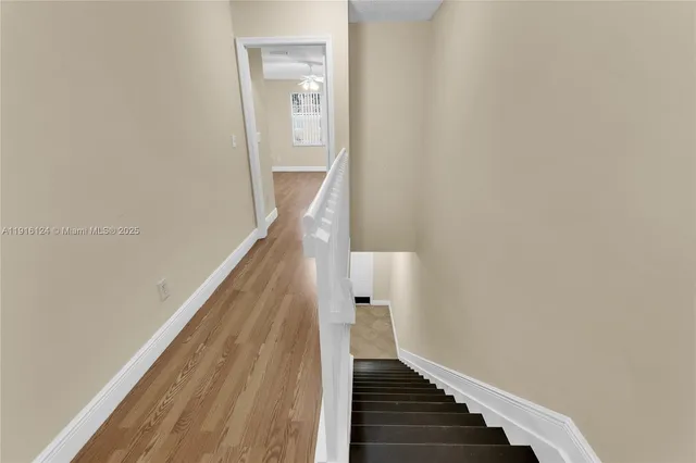 a view of a swimming pool with a table and chairs under an umbrella