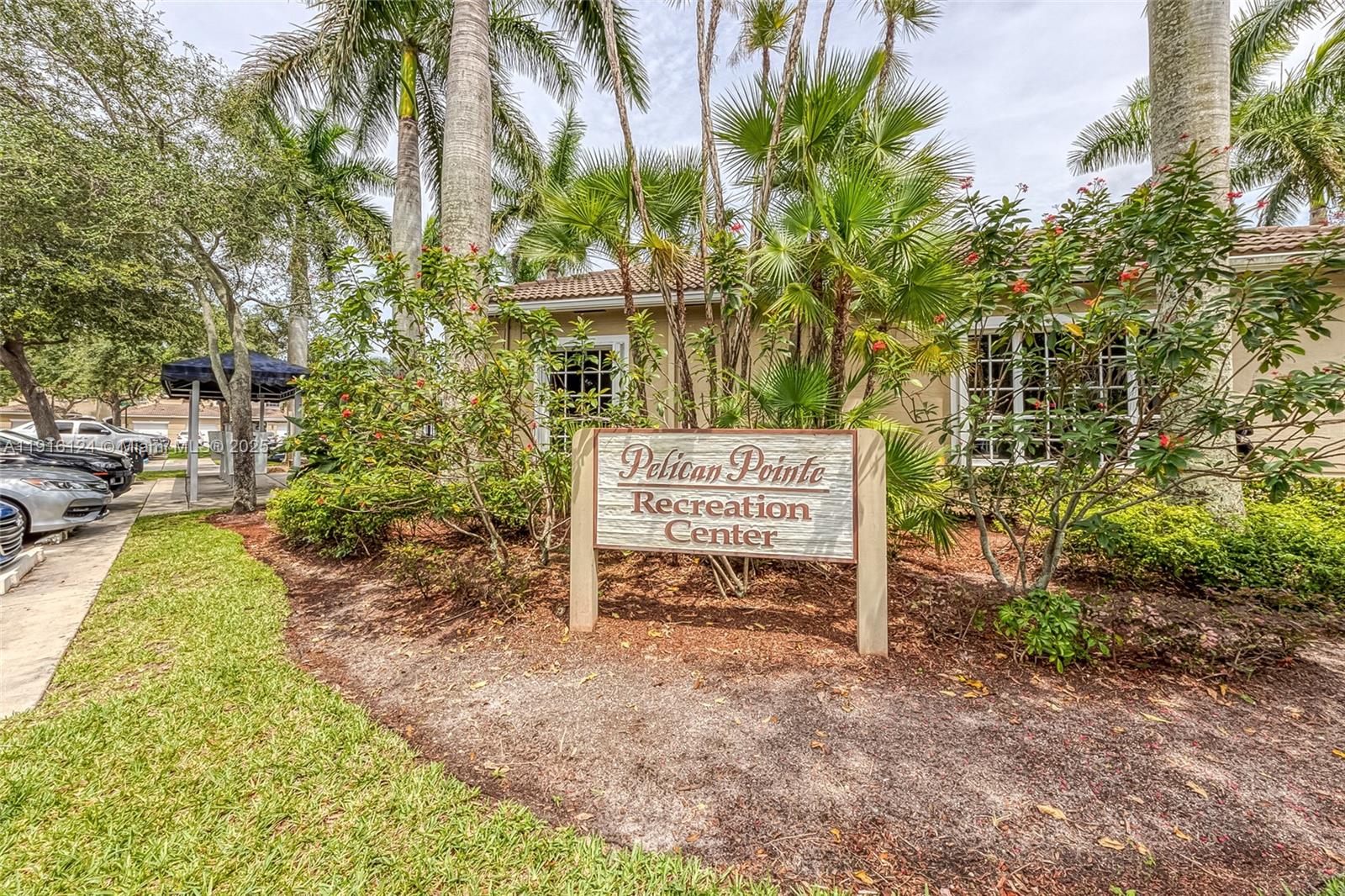 304 Southwest 120th Avenue, Unit 304 Pembroke Pines, FL 33025 - Photo 36 of 46 a sign board with tall trees