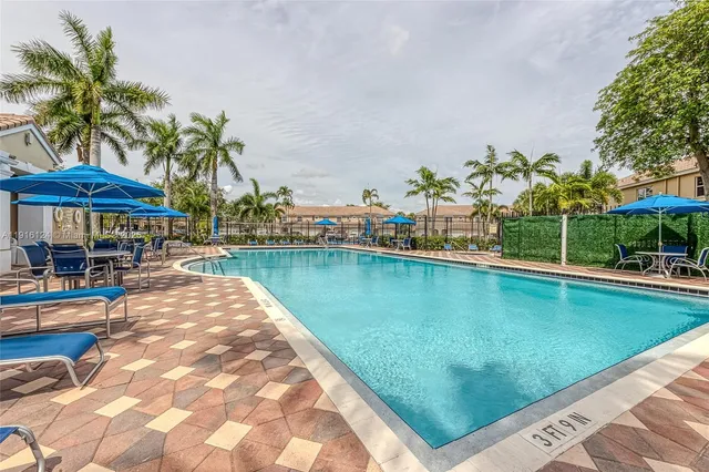 a view of swimming pool with outdoor seating and plants