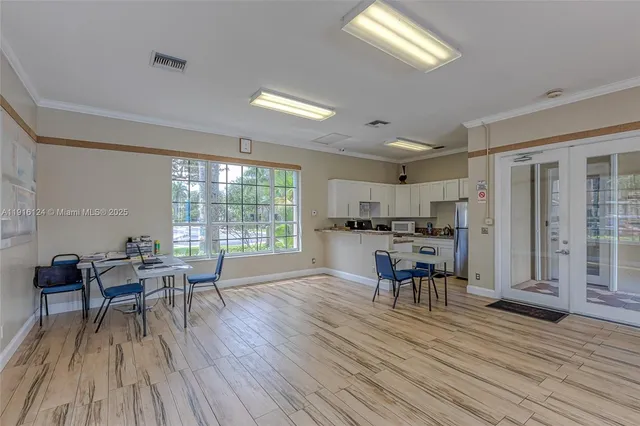 a room with gym equipment and potted plants