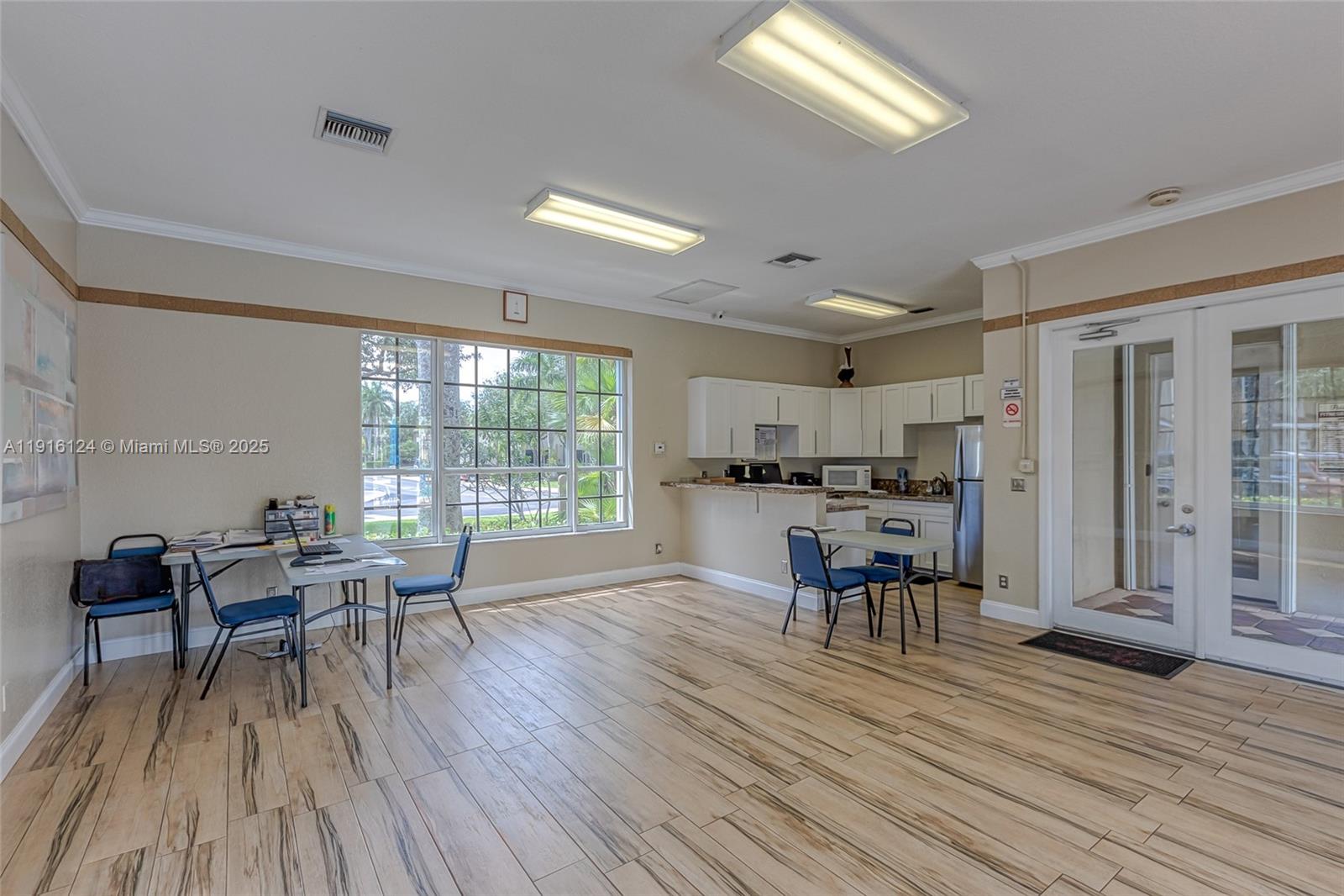 304 Southwest 120th Avenue, Unit 304 Pembroke Pines, FL 33025 - Photo 42 of 46 a view of a dining room with furniture and wooden floor