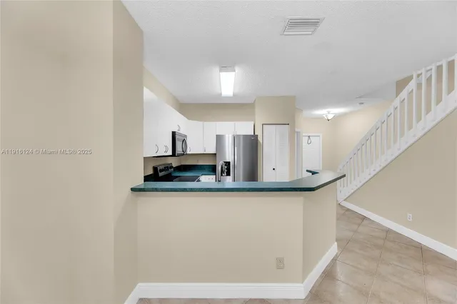a view of a kitchen with wooden floor