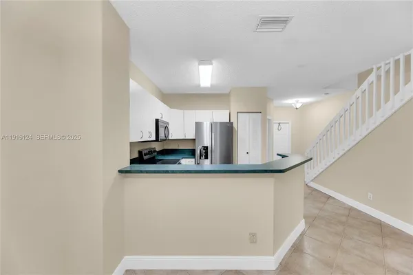 a view of a kitchen with wooden floor