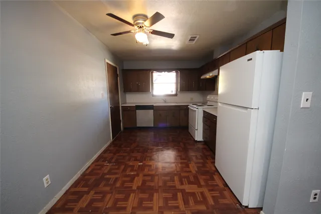 a kitchen with a refrigerator a sink and dishwasher