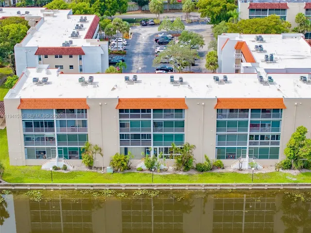 a view of a house with a backyard and a table and chairs