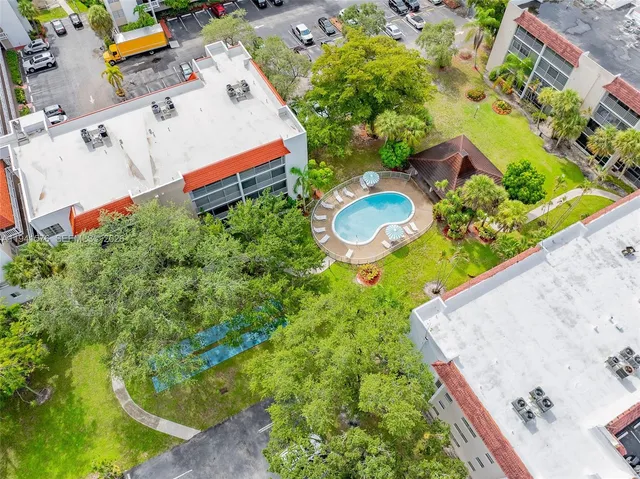 an aerial view of a house with a yard basket ball court and outdoor seating