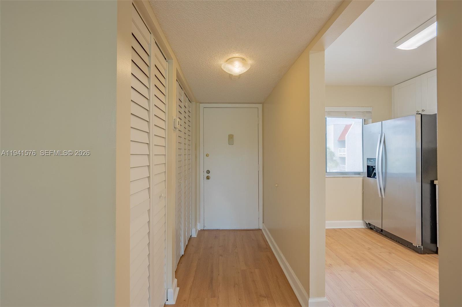 3581 Inverrary Drive, Unit 308 Lauderhill, FL 33319 - Photo 23 of 43 a view of a hallway with wooden floor and a bathroom