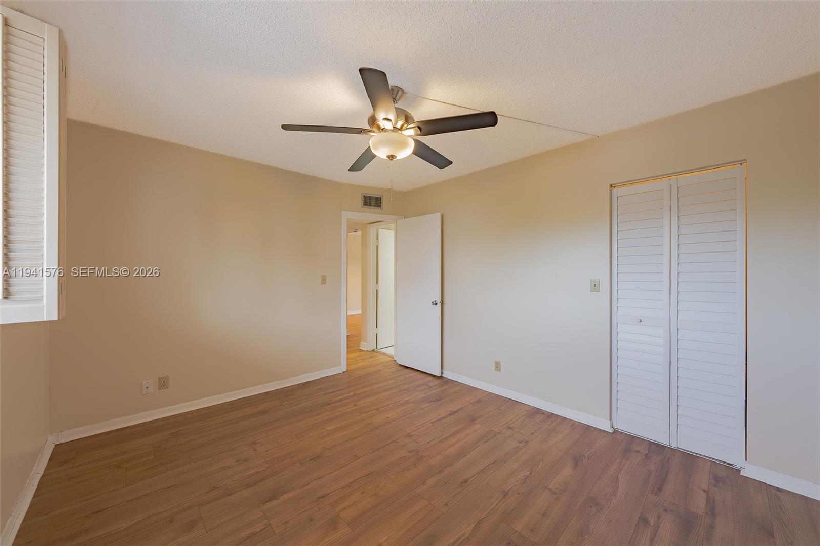 3581 Inverrary Drive, Unit 308 Lauderhill, FL 33319 - Photo 31 of 43 a view of a big room with wooden floor and a ceiling fan