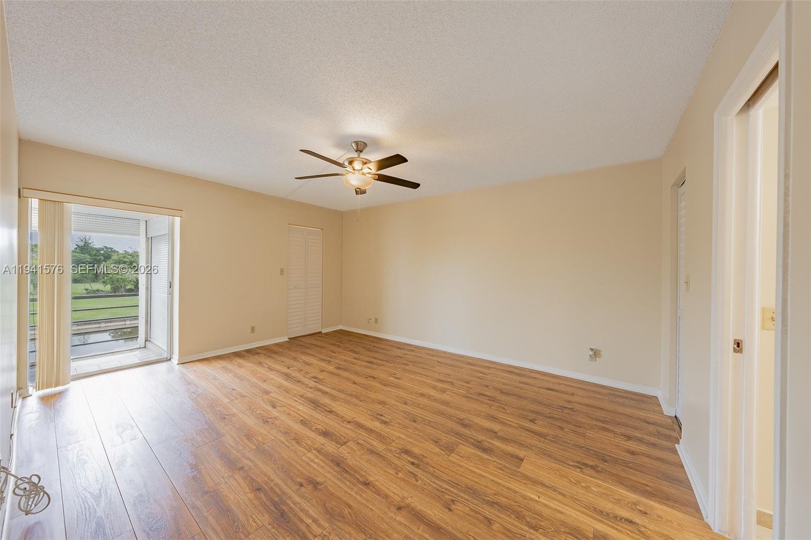 3581 Inverrary Drive, Unit 308 Lauderhill, FL 33319 - Photo 37 of 43 a view of an empty room with wooden floor and a window