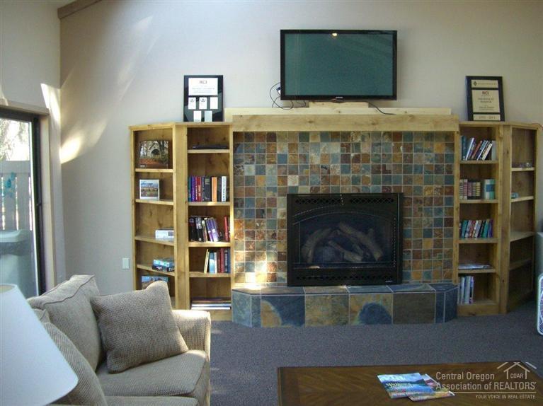 57395 Beaver Ridge Loop, Unit 40 A1 Sunriver, OR 97707 - Photo 25 of 25 a living room with furniture and a fireplace