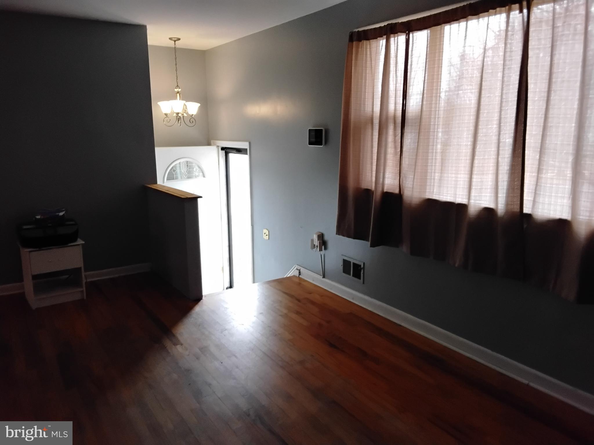 11422 Brandywine Road Clinton, MD 20735 - Photo 15 of 18 wooden floor in an empty room with a window