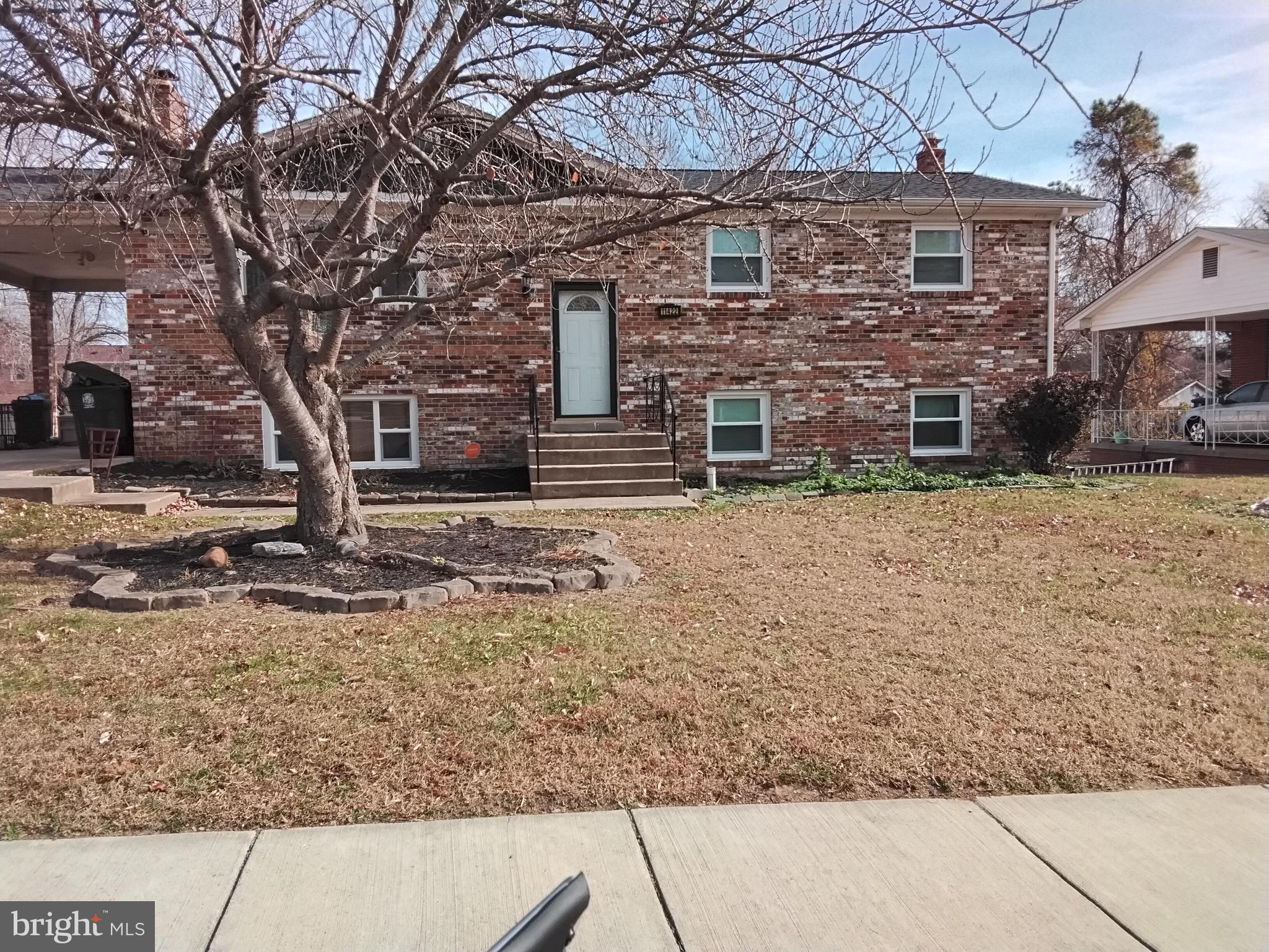 11422 Brandywine Road Clinton, MD 20735 - Photo 2 of 18 a front view of a house with a yard