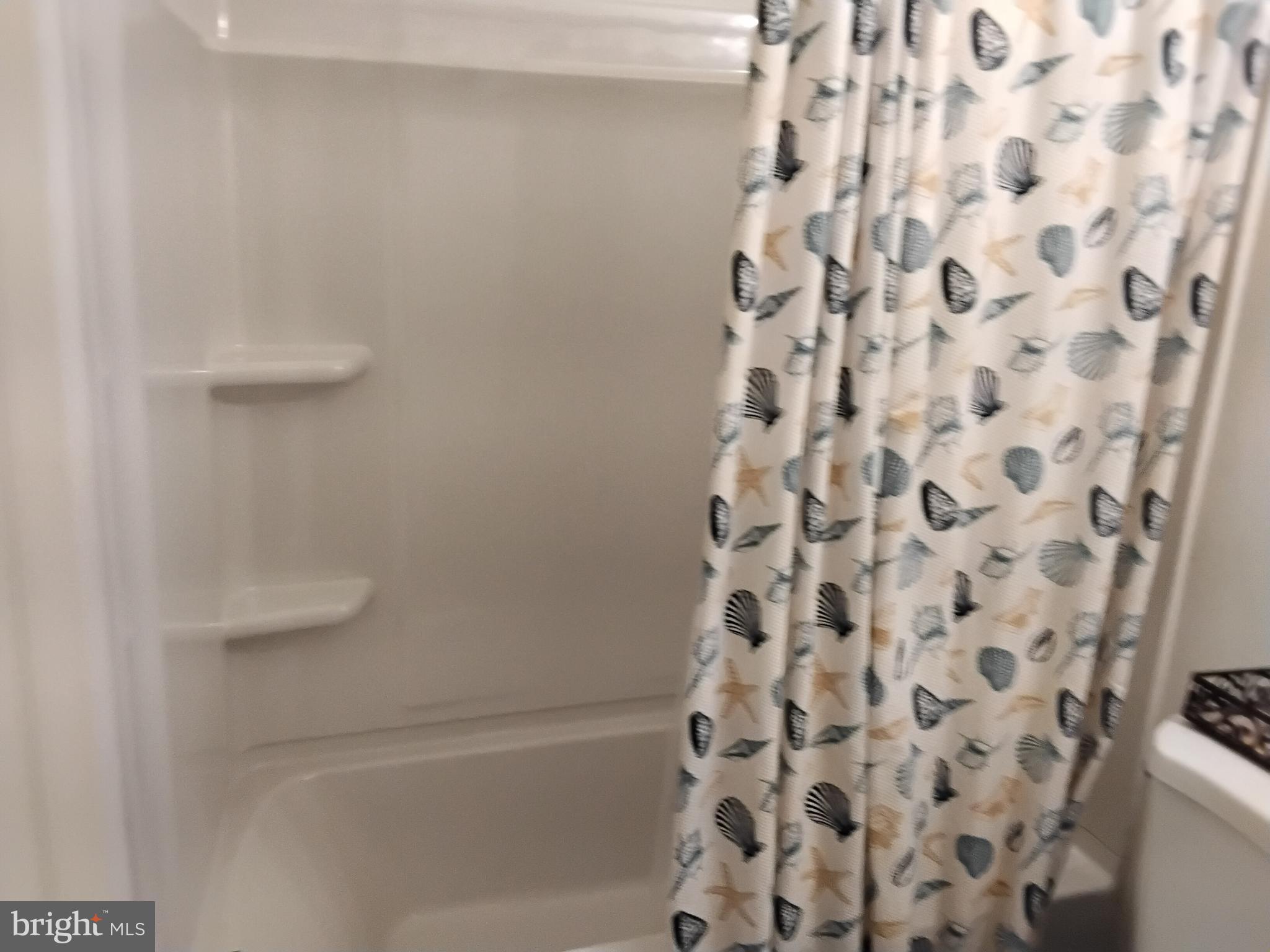 11422 Brandywine Road Clinton, MD 20735 - Photo 9 of 18 a bathroom with a bathtub and a shower