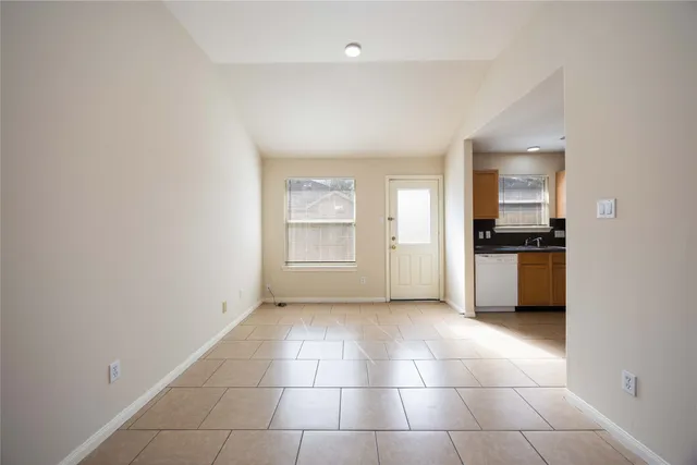a view of a kitchen with an empty space and a window