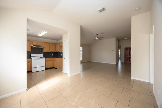 a view of a kitchen with a sink and a refrigerator