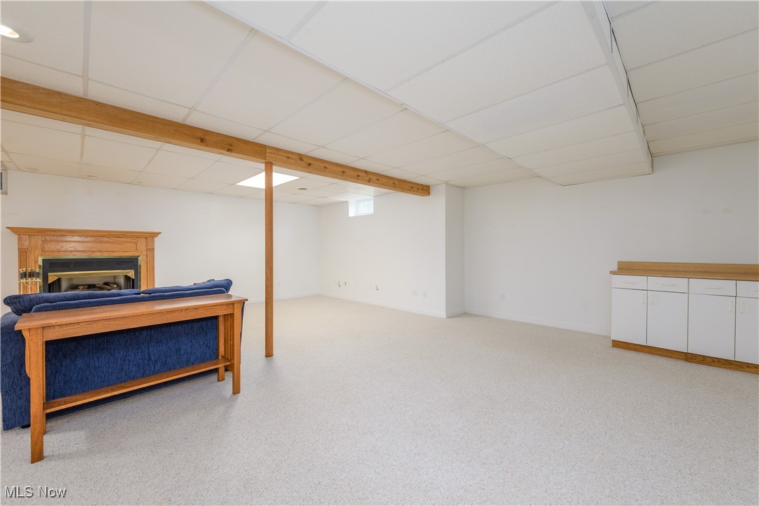 1435 Industry Road Atwater, OH 44201 - Photo 31 of 48 Lower level rec. room with a paneled ceiling and light colored carpet