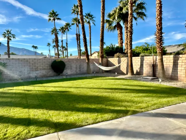 a view of a swimming pool with a yard