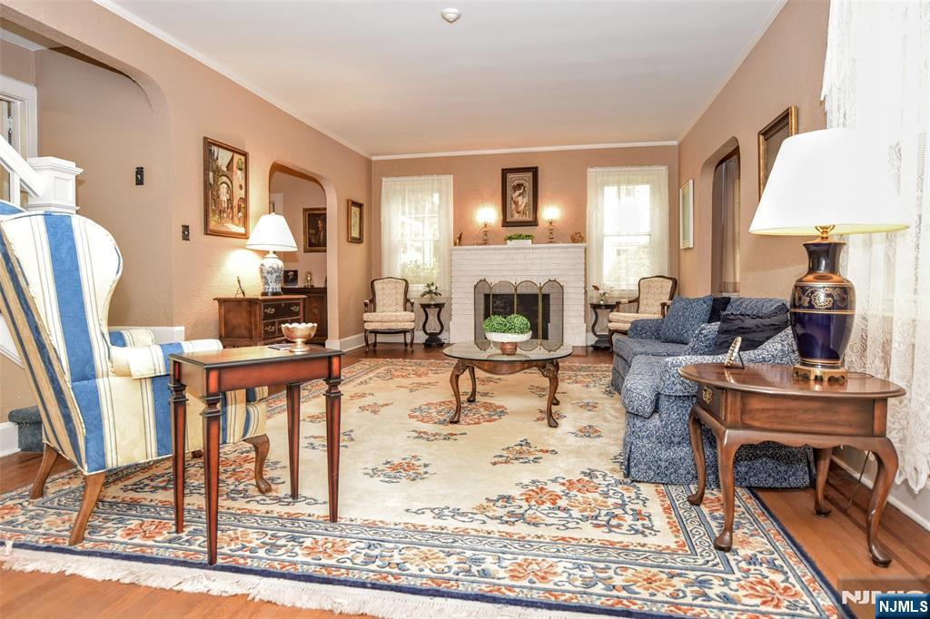 255 Pearsall Avenue Ridgewood, NJ 07450 - Photo 6 of 39 a living room with furniture a fireplace and a table