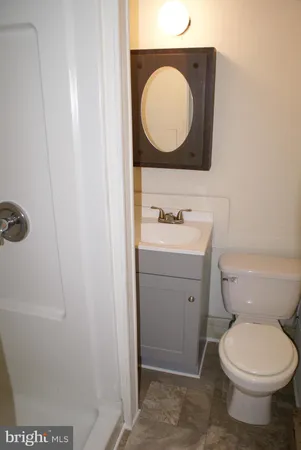 a bathroom with a toilet sink and mirror