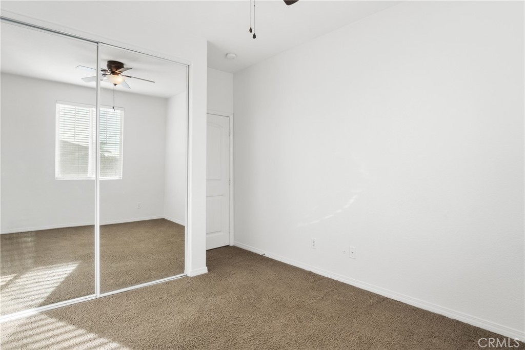 30272 Tattersail Way Menifee, CA 92584 - Photo 11 of 44 an empty room with windows