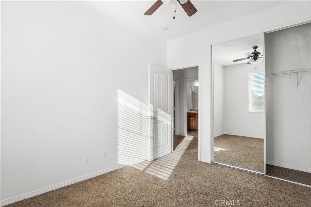 30272 Tattersail Way Menifee, CA 92584 - Photo 14 of 44 an empty room with windows and closet