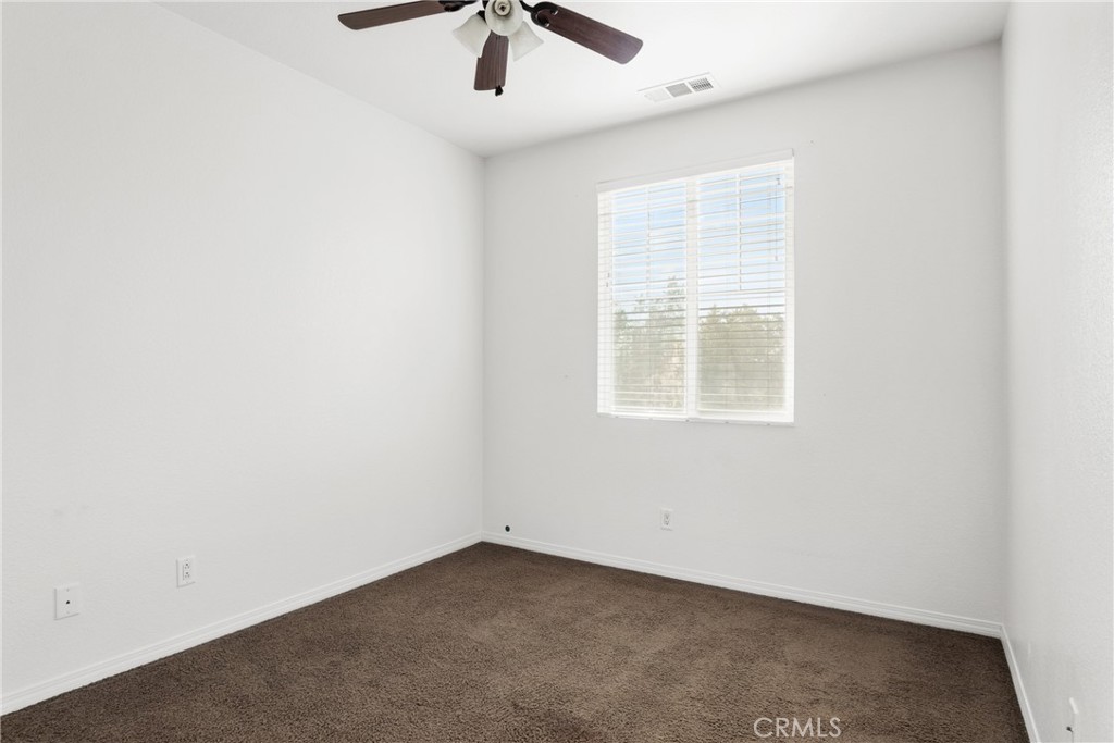30272 Tattersail Way Menifee, CA 92584 - Photo 15 of 44 an empty room with a window and a fan