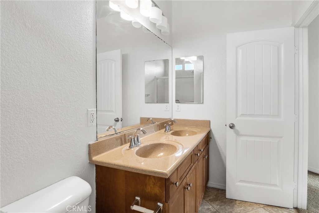 30272 Tattersail Way Menifee, CA 92584 - Photo 16 of 44 a bathroom with a sink a vanity and a mirror