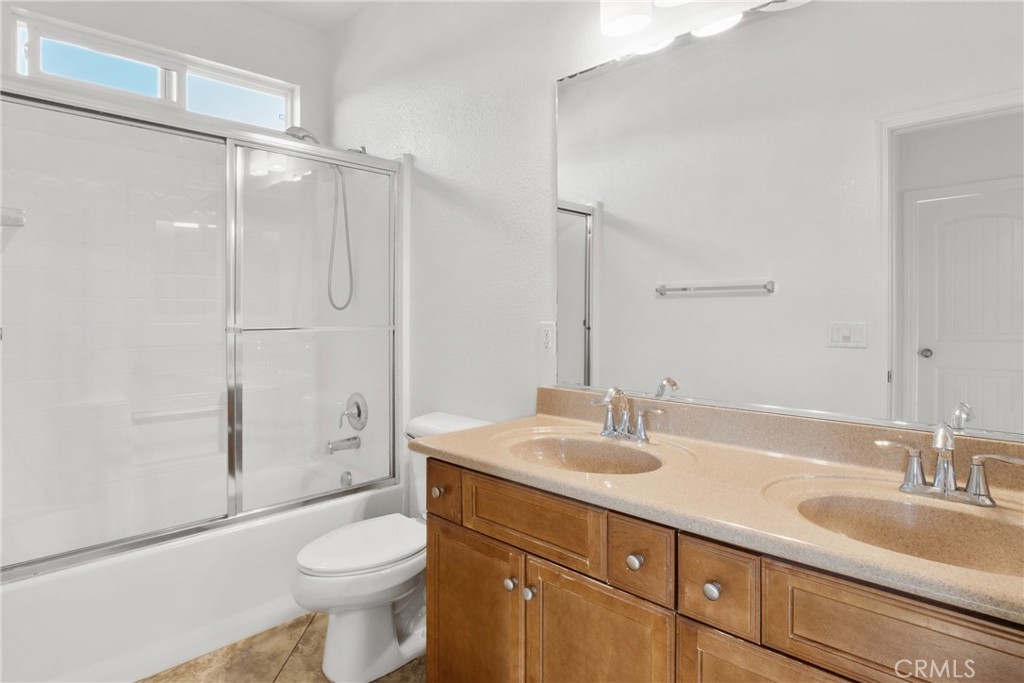 30272 Tattersail Way Menifee, CA 92584 - Photo 17 of 44 a bathroom with a sink toilet double vanity and shower